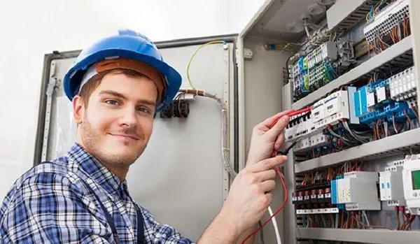 Electrician checking a fuse box